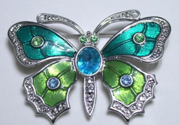 Butterfly brooch in sterling silver with blue green mother of pearl enamel and cabochons Butterfly brooch in sterling silver with blue green mother of pearl enamel and cabochons