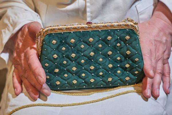 Emerald velvet handbag with gold accents. Emerald velvet handbag with gold accents.