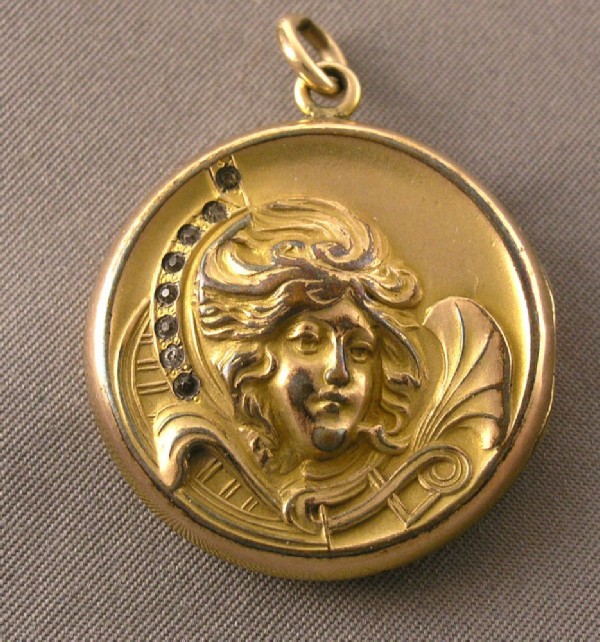 Round gold pendant with an image of an angel. Round gold pendant with an image of an angel.
