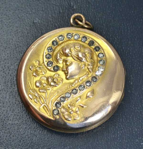 Round medallion with an image of an angel with rhinestones. Round medallion with an image of an angel with rhinestones.