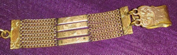Wide gold plated bracelet with chains. Wide gold plated bracelet with chains.