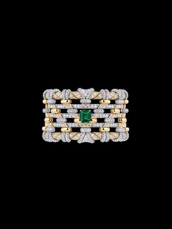 A gold ring with diamonds and an emerald. A gold ring with diamonds and an emerald.