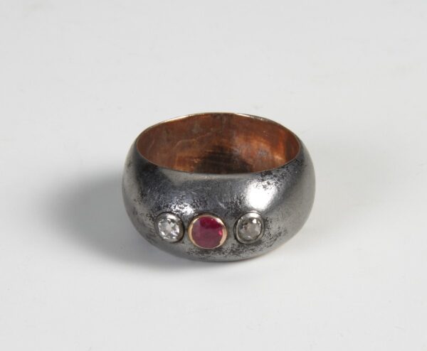 A silver ring with a ruby. A silver ring with a ruby.